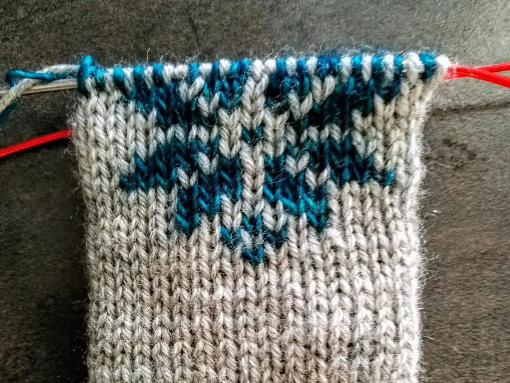 Double knitting a baby mitten.