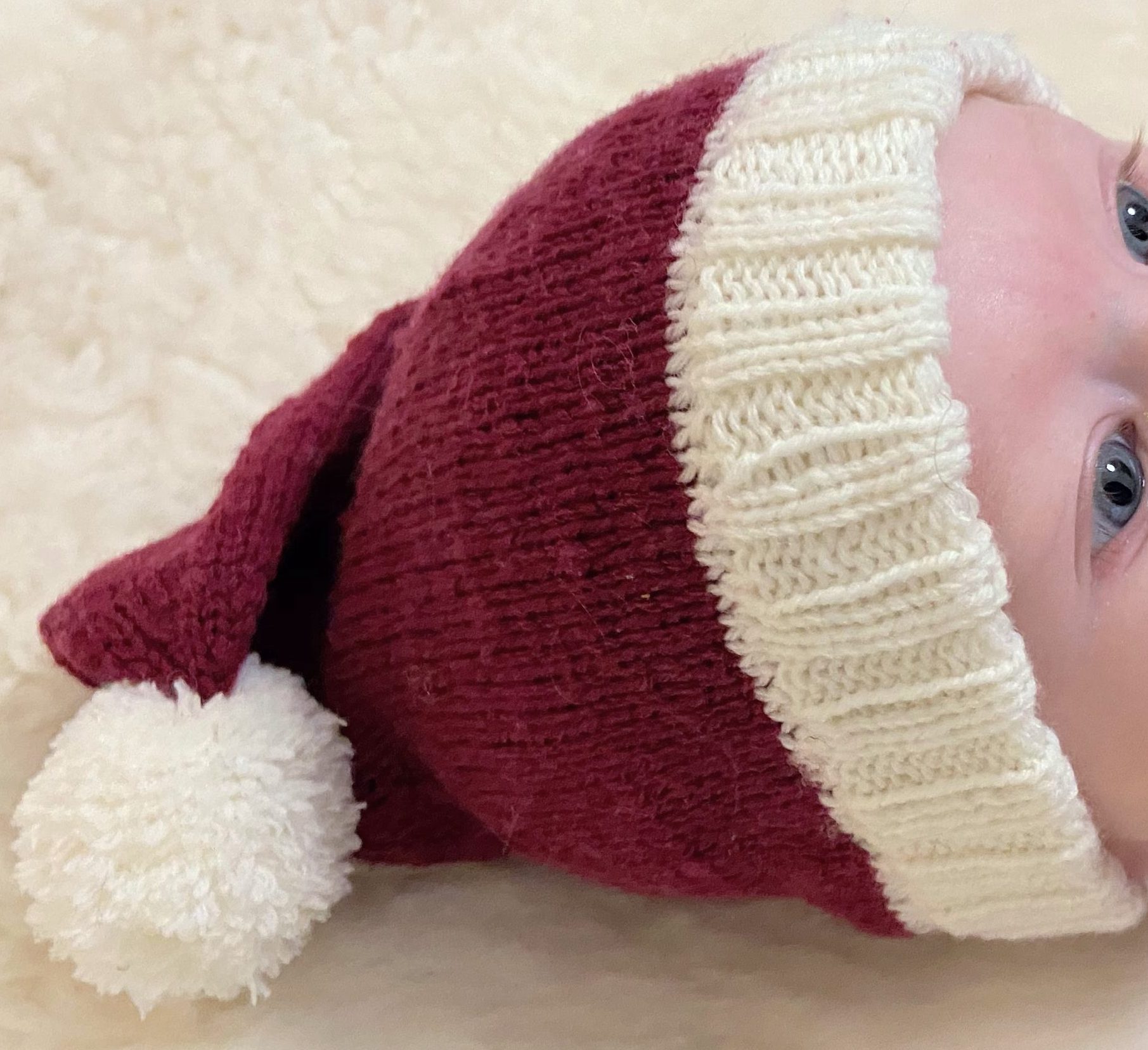 Knitted santa hat for a baby.