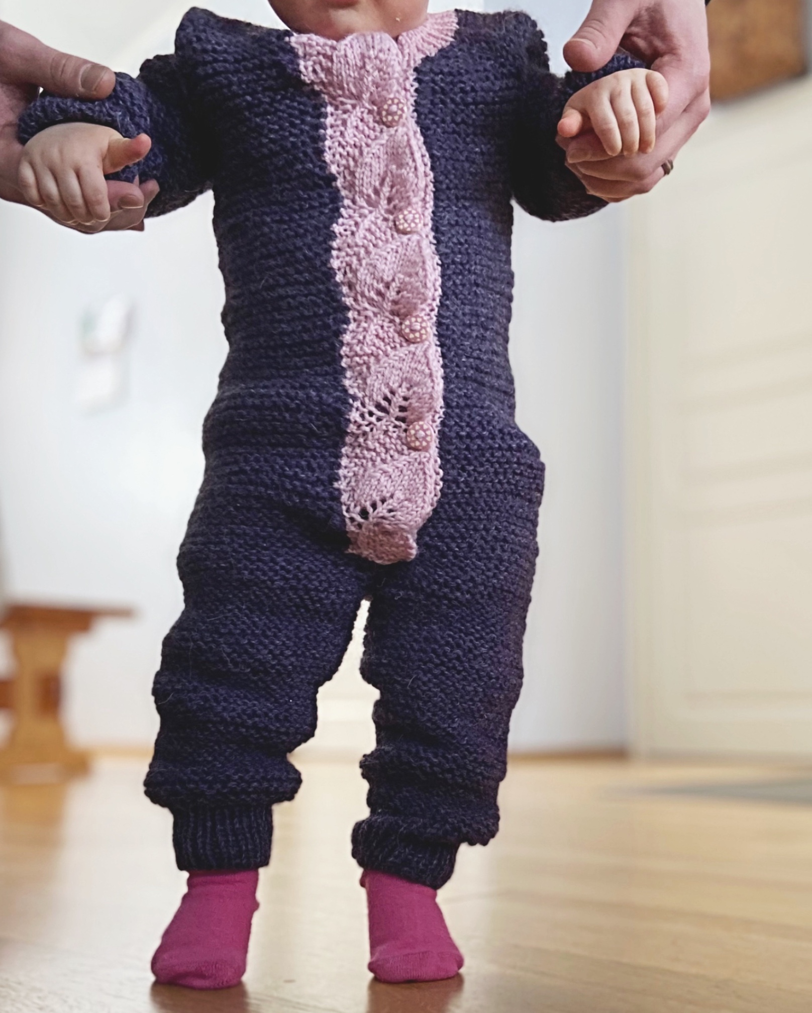 Baby overall knitted with garter stitch. Button band is made of knitted leaves.